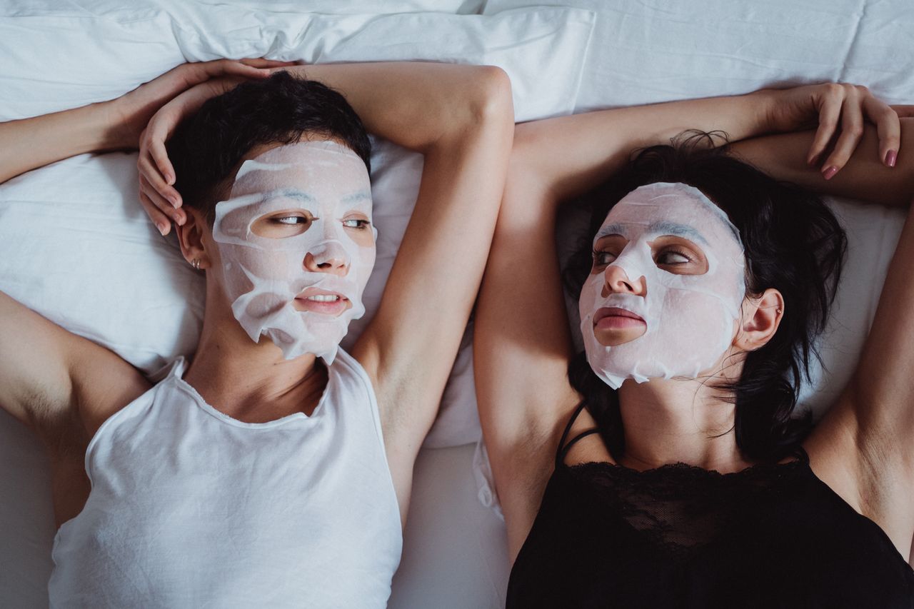 Crafting Captivating Headlines: Your awesome post title goes here Two people enjoying a facial sheet mask skincare ritual together indoors.